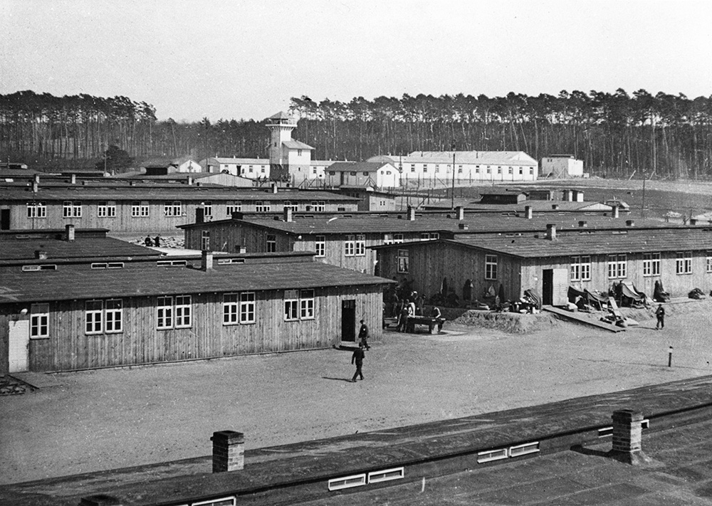 Black and white photograph of rows of barrack structures